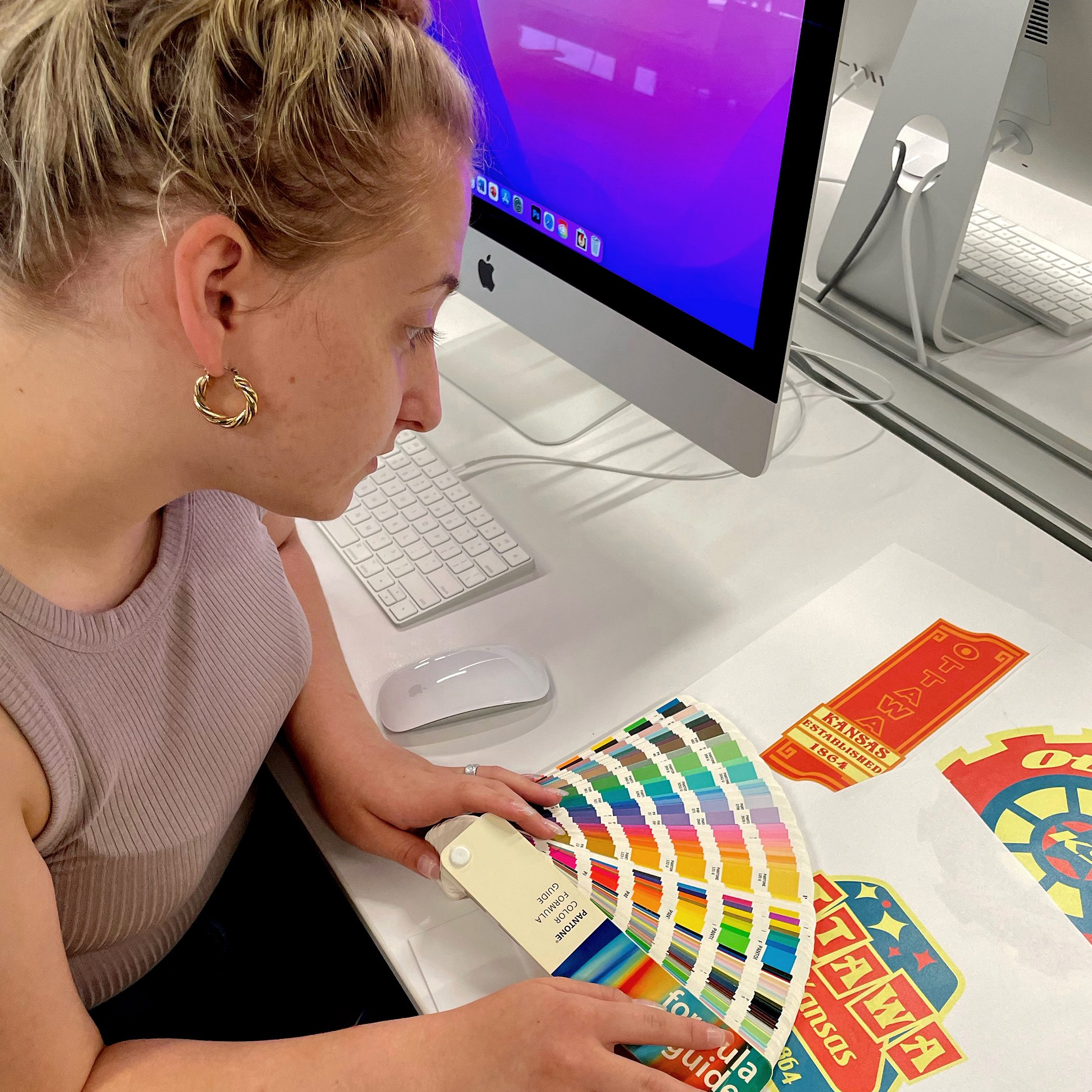 Student Viewing the Pantone Color Formula Guide to Assist with a Project